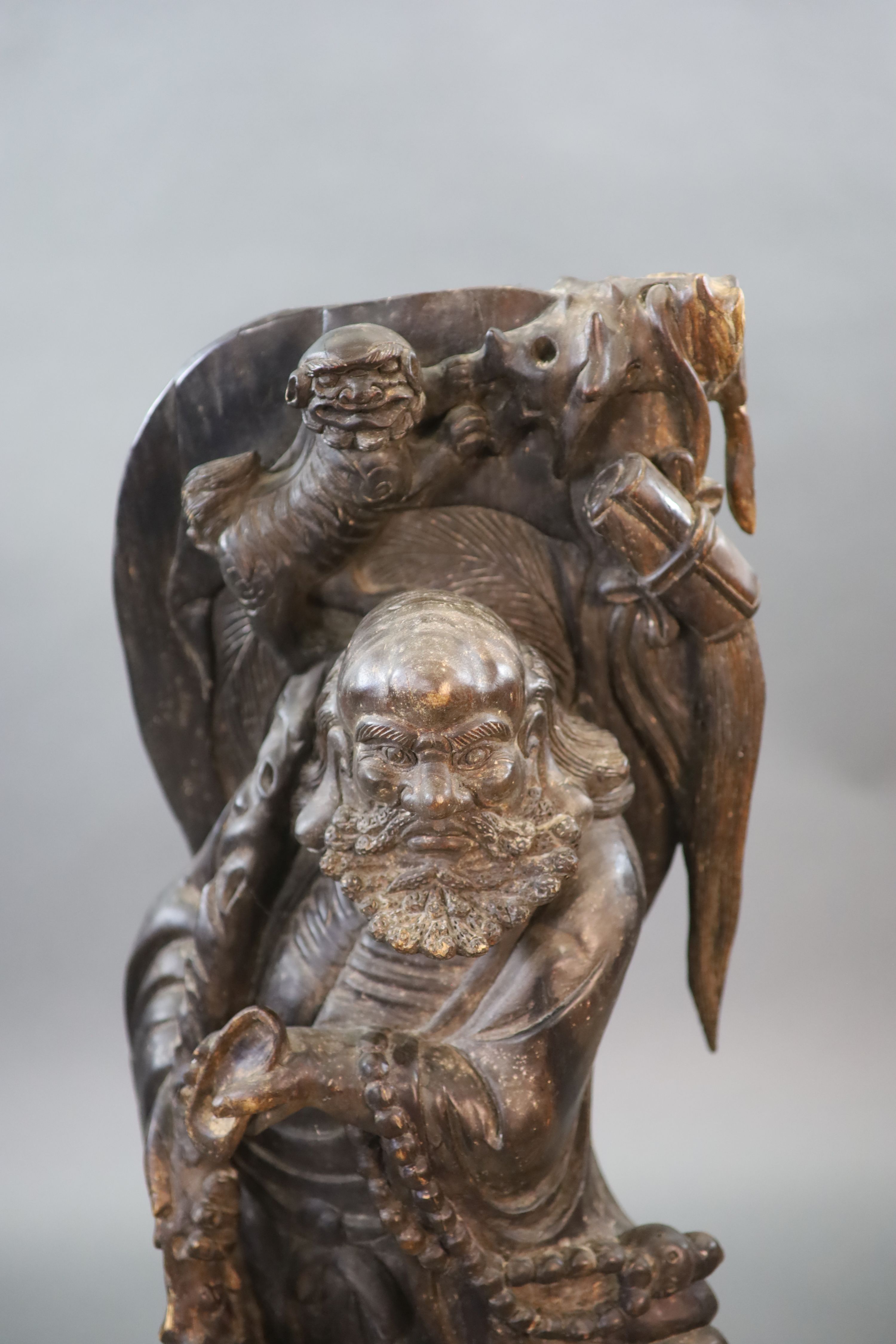 An early 20th Chinese carved hardwood figure of a Luohan